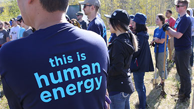 Employees wearing Human Energy shirts at a tree planting event