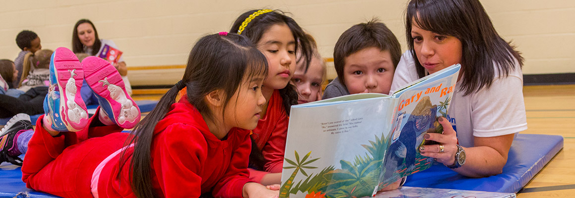 Chevron employee reading to childern at Calgary Reads event