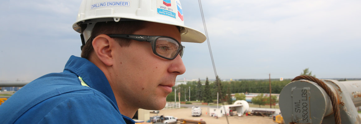 Chevron employees looking out over a drilling site