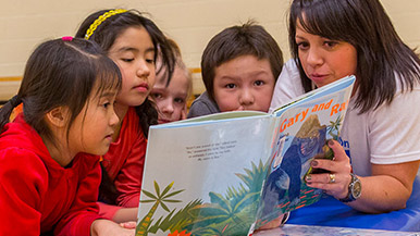 Chevron employee reading to childern at Calgary Reads event