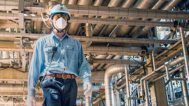 Person with mask walking at Chevron facility