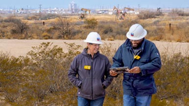 Two chevron employees talking with a clip board