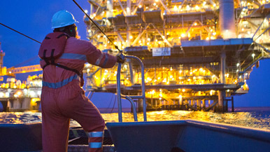 A ship approaching an offshore oil platform