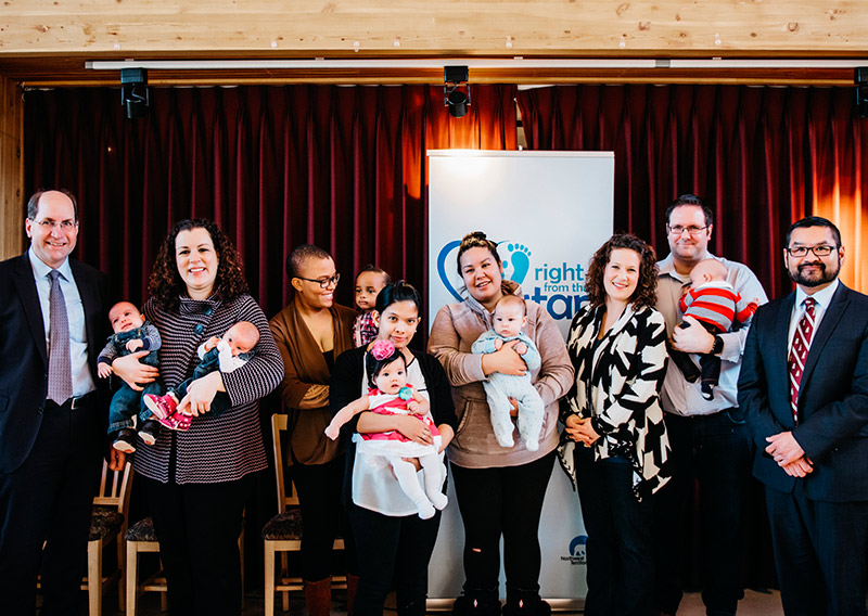 Rod Maier, Chevron Canada’s manager of Policy, Government and Public Affairs (far left), and Alfred Moses, minister of Education, Culture and Employment for the Government of the Northwest Territories (far right), with new parents at the iPad Mini Initiative launch event on April 12 in Yellowknife.