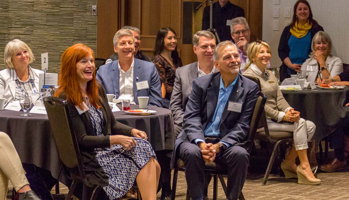 Campus Calgary Open Minds guests watch presentation