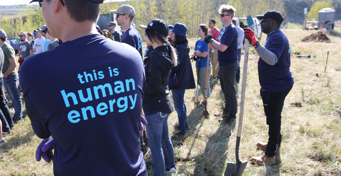 Employees at a tree planting event with Human Energy shirts