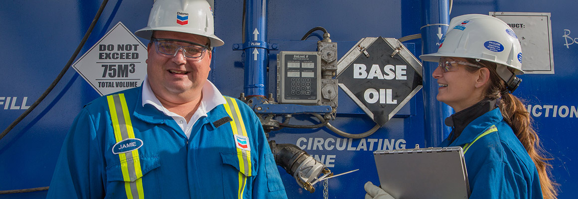 Chevron employees talking at a well in the Kaybob Duvernay region of West-Central region of Alberta